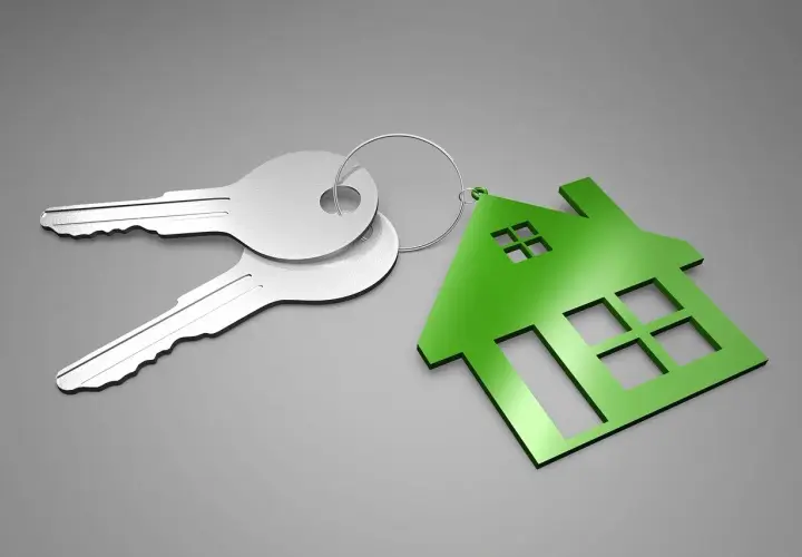 Dos llaves plateadas y un llavero con forma de casa verde. ¿Qué es el aval ico? Es la llave de tu nuevo hogar.