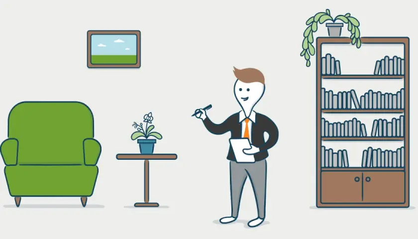 Un hombre con traje revisa un bien inmueble, con un sillón verde, una planta y una estantería llena de libros.