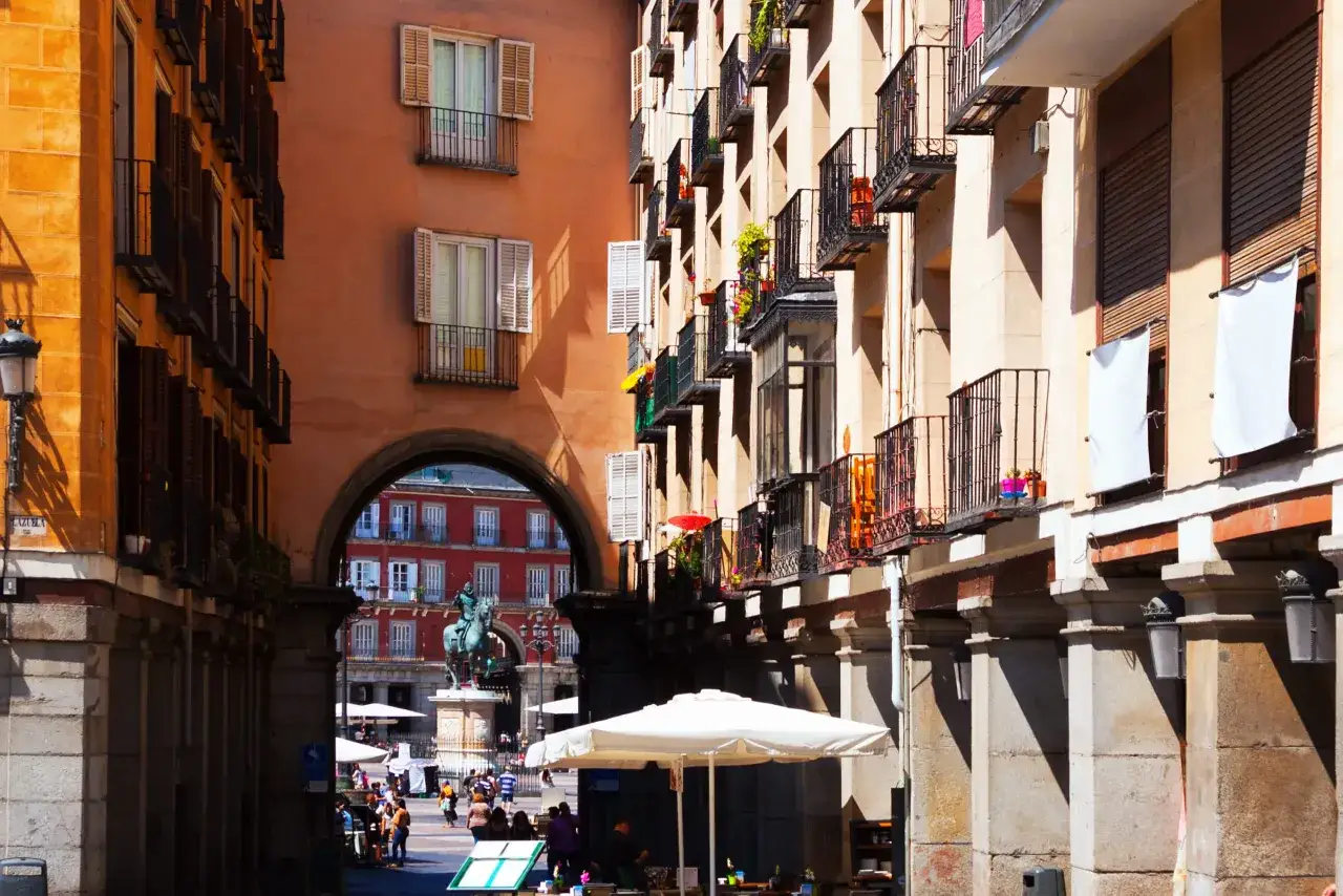 Vista de un predio con arquitectura clásica, balcones y una estatua ecuestre en la plaza.