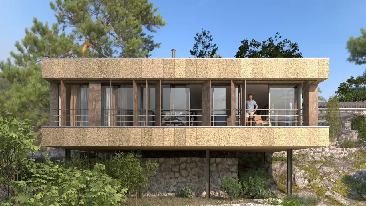 Una casa moderna con fachada de corcho y grandes ventanales, que se alza sobre pilares. Un ejemplo de los diversos tipos de casas que se integran en el paisaje.